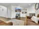 Open-concept living room with stylish decor, and a view of the modern kitchen at 7361 Ringquist St, Las Vegas, NV 89148