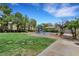 The community playground features a slide and swings set on a well maintained green lawn at 7361 Ringquist St, Las Vegas, NV 89148