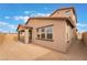 Exterior angle of house showcasing the backyard, covered patio, and desert landscaping, highlighting architectural details at 789 Black Palace St, Henderson, NV 89011