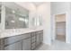 Modern bathroom with double sink vanity, large mirror, and a view into the tiled shower at 789 Black Palace St, Henderson, NV 89011