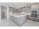 A sleek kitchen features a large island, gray cabinets, and stainless steel appliances at 789 Black Palace St, Henderson, NV 89011