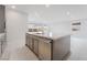 Kitchen island featuring stainless steel dishwasher, sink and seating area, with view to living room at 789 Black Palace St, Henderson, NV 89011
