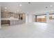 Open-concept kitchen and living area with tile flooring, gray cabinetry, and a sliding glass door at 789 Black Palace St, Henderson, NV 89011