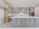 Modern kitchen boasts gray cabinetry, an expansive island, and stainless steel appliances at 789 Black Palace St, Henderson, NV 89011