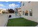 Home includes private back yard with green lawn, grill, and shade at 8566 Burning Bridge Ct, Las Vegas, NV 89131