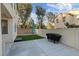 Private backyard patio featuring a small green space, neutral block wall, and light tan fencing at 8566 Burning Bridge Ct, Las Vegas, NV 89131