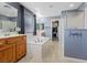 Luxurious primary bathroom with double vanity, bathtub, walk-in shower, and walk-in closet at 8566 Burning Bridge Ct, Las Vegas, NV 89131