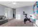 Bonus room with ceiling fan, gray walls, and colorful artwork on the back wall at 8566 Burning Bridge Ct, Las Vegas, NV 89131