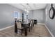 Elegant dining room with a large table, comfortable chairs, modern lighting and wood flooring at 8566 Burning Bridge Ct, Las Vegas, NV 89131