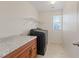 Laundry room includes new washer and dryer, countertop and built-in cabinet at 8566 Burning Bridge Ct, Las Vegas, NV 89131