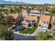 Beautiful aerial view of a suburban home featuring a well-manicured lawn, tile roof, and desert landscape at 8848 Rainbow Ridge Dr, Las Vegas, NV 89117