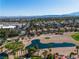 A sprawling community with lush landscaping, showcasing desert homes, a pond, and a well-manicured golf course at 8848 Rainbow Ridge Dr, Las Vegas, NV 89117