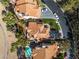Expansive aerial view showcases desert home with a tile roof and private backyard pool at 8848 Rainbow Ridge Dr, Las Vegas, NV 89117