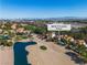Fantastic aerial view overlooking a luxury desert home near a pond and golf course with a city view at 8848 Rainbow Ridge Dr, Las Vegas, NV 89117