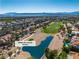 Aerial view of the home and surrounding golf course community with mountain views at 8848 Rainbow Ridge Dr, Las Vegas, NV 89117