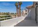 Balcony overlooking a desert landscape with views of palm trees and other homes at 8848 Rainbow Ridge Dr, Las Vegas, NV 89117