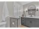 Bright bathroom with gray cabinets, a marble countertop and modern lighting fixtures at 8848 Rainbow Ridge Dr, Las Vegas, NV 89117