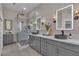 This modern bathroom boasts dual sinks, quartz counters, and a luxurious glass shower at 8848 Rainbow Ridge Dr, Las Vegas, NV 89117