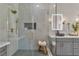 Walk-in shower features marble walls, chevron flooring, and luxurious gold fixtures and hardware at 8848 Rainbow Ridge Dr, Las Vegas, NV 89117