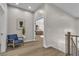 Hallway featuring wood floors, a chair, and access to an adjacent bedroom at 8848 Rainbow Ridge Dr, Las Vegas, NV 89117