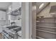 Walk-in pantry featuring ample shelving space, next to a chef's kitchen with stainless steel appliances at 8848 Rainbow Ridge Dr, Las Vegas, NV 89117