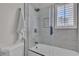 Walk-in shower with white tile walls, glass enclosure, and overhead shower head at 8848 Rainbow Ridge Dr, Las Vegas, NV 89117