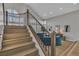 Staircase leading to a sitting area with a large curved window and wood flooring at 8848 Rainbow Ridge Dr, Las Vegas, NV 89117