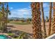 View of a golf course and mountain landscape with palm trees at 8848 Rainbow Ridge Dr, Las Vegas, NV 89117