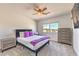 Comfortable bedroom with carpeted floors, a ceiling fan, and a large window offering neighborhood views at 9124 Sapphire Ridge Ave, Las Vegas, NV 89129