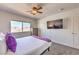 Bright bedroom with carpeted floors, a ceiling fan, and a large window with mountain views at 9124 Sapphire Ridge Ave, Las Vegas, NV 89129