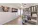 Bright bedroom featuring a bunk bed, wooden floors, a ceiling fan, and colorful elephant wall art at 9124 Sapphire Ridge Ave, Las Vegas, NV 89129