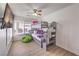 Cozy bedroom with a gray bunk bed, ceiling fan, and a comfortable green beanbag chair near the window at 9124 Sapphire Ridge Ave, Las Vegas, NV 89129