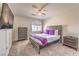 Inviting bedroom showcasing a queen bed, a ceiling fan, plush carpet, and a mounted TV at 9124 Sapphire Ridge Ave, Las Vegas, NV 89129