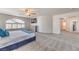 Expansive bedroom featuring plush carpeting, TV, a bright window and an open layout at 9124 Sapphire Ridge Ave, Las Vegas, NV 89129