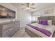 Comfortable bedroom boasts a queen bed, a ceiling fan, and a mounted TV at 9124 Sapphire Ridge Ave, Las Vegas, NV 89129