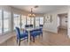Cozy dining area featuring modern lighting, plantation shutters, and views of the pool at 9124 Sapphire Ridge Ave, Las Vegas, NV 89129