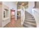 Grand foyer featuring a curved staircase, an open floor plan, and access to a bar area at 9124 Sapphire Ridge Ave, Las Vegas, NV 89129