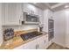 Well-equipped kitchen featuring stainless steel appliances, granite countertops, and white cabinets for ample storage at 9124 Sapphire Ridge Ave, Las Vegas, NV 89129