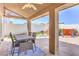 Charming covered patio with an outdoor dining set and a grill for outdoor entertainment at 9124 Sapphire Ridge Ave, Las Vegas, NV 89129