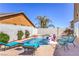 The pool featuring lounge chairs, clear blue water, and beautiful landscaping, perfect for summer relaxation and enjoyment at 9124 Sapphire Ridge Ave, Las Vegas, NV 89129