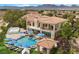 Expansive aerial view of a luxury home with a pool, sports court, and manicured landscaping at 9301 Verlaine Ct, Las Vegas, NV 89145