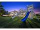 Spacious backyard featuring a play structure and pristine landscaping, perfect for outdoor fun at 9301 Verlaine Ct, Las Vegas, NV 89145