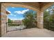Covered balcony featuring stone columns, wrought iron railings and views of the surrounding area at 9301 Verlaine Ct, Las Vegas, NV 89145