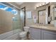 Bathroom features a glass shower, vanity with marble countertop, and framed mirror at 9301 Verlaine Ct, Las Vegas, NV 89145