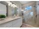 Bathroom featuring a glass shower with a bench, a sink with white cabinets, and a mirror at 9301 Verlaine Ct, Las Vegas, NV 89145