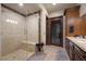 Beautiful bathroom features a walk-in shower with marble tile and a wood vanity at 9301 Verlaine Ct, Las Vegas, NV 89145