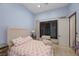 Cozy bedroom with a tufted headboard, stylish bedding, and wooden shutters for natural light control at 9301 Verlaine Ct, Las Vegas, NV 89145
