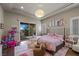 ' bedroom features a private balcony, pink accents, hardwood floors and custom decor at 9301 Verlaine Ct, Las Vegas, NV 89145