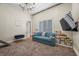 Bedroom with blue sofa, window with blinds, and carpeted floor at 9301 Verlaine Ct, Las Vegas, NV 89145