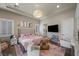 Bright bedroom with hardwood floors, shutters, a TV and stylish decor at 9301 Verlaine Ct, Las Vegas, NV 89145